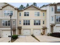 Two-story townhome with attached garage and neutral exterior at 1801 Liberty Nw Pkwy, Atlanta, GA 30318