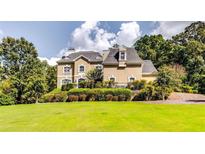 Grand two-story house with manicured lawn at 4280 Sandstone Shores Dr, Lithonia, GA 30038