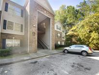 Brick apartment building with a covered entrance and parking at 3217 Fairington Dr, Lithonia, GA 30038