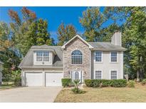 Two-story house with stone accents and two-car garage at 1983 Smithfield Ave, Ellenwood, GA 30294