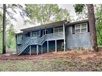 Raised ranch home with a deck, offering a unique exterior at 124 Brookwood Dr, Canton, GA 30114