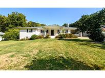 Ranch house with white brick exterior and large yard at 2620 Old Covington Ne Rd, Conyers, GA 30013