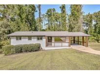 Ranch style home with covered porch and landscaped yard at 3611 Hillsborough Ln, Decatur, GA 30032