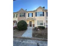 Two-story townhouse with a yellow exterior and a walkway leading to the entrance at 2805 Vining Ridge Ter, Decatur, GA 30034