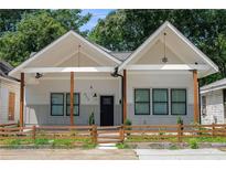 Charming craftsman style home with a white exterior, wood accents, and a landscaped front yard at 865 Mcdaniel Sw St, Atlanta, GA 30310