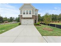 Two-story home with stone accents and a two-car garage at 5760 Tillman Way, Powder Springs, GA 30127