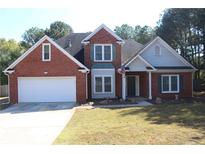 Two story brick home with gray accents and a white garage door at 2905 Windsong Park Ln, Dacula, GA 30019