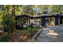Mid-Century modern home with stone pathway, nestled in a wooded setting at 922 Barton Woods Ne Rd, Atlanta, GA 30307