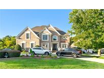 Brick two-story house with a large front yard and a three-car driveway at 4478 Thurgood Estates Dr, Ellenwood, GA 30294