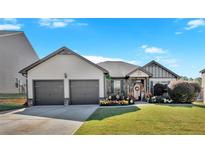 Two-story house with two-car garage and well-manicured lawn at 911 Mcduffie Cir, Douglasville, GA 30134
