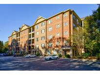 Brick building exterior with ample parking at 2300 Peachford Rd # 1205, Dunwoody, GA 30338