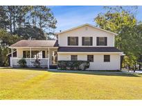 Two-story house with covered porch and green lawn at 75 Lundy Ln, Jonesboro, GA 30238