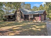 Single story home with stone fireplace and attached garage at 764 New Hope Dr, Hampton, GA 30228