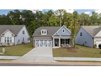 Craftsman style home with gray siding and stone accents at 51 Airmont Dr, Sharpsburg, GA 30277