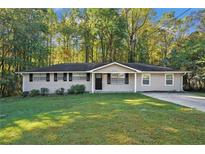 A charming ranch-style house with a well-maintained lawn at 3881 Nations Dr, Douglasville, GA 30135