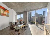 Living room with floor-to-ceiling windows and city views at 400 W Peachtree Nw St # 2011, Atlanta, GA 30308