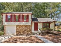 Ranch style home with stone accents and red shutters at 5035 Fairforest Dr, Stone Mountain, GA 30088