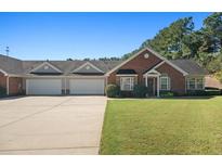 Brick front townhouse with a two car garage at 204 Somerton Pl, Cumming, GA 30040