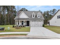 Craftsman style home with a two-car garage and covered front porch at 134 Airmont Dr, Sharpsburg, GA 30277