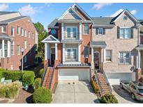 Brick three-story townhome with double door entry and attached garage at 1281 Creekside Se Pl, Smyrna, GA 30082