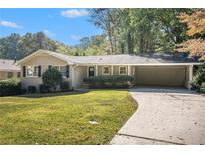 Ranch home with carport and expansive lawn at 2740 Old Spanish Trl, Atlanta, GA 30349