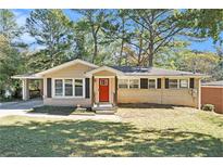 Charming ranch home with red door and landscaped yard at 2434 Miriam Ln, Decatur, GA 30032