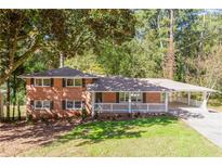 Ranch-style brick home with white porch at 504 Milligan Dr, Stone Mountain, GA 30083