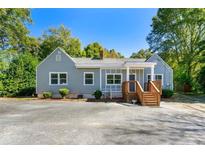 Cute ranch home with gray siding, wooden deck, and ample parking at 312 Candler Se Rd, Atlanta, GA 30317