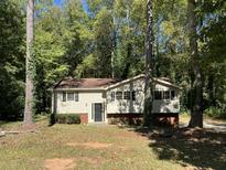House exterior with wood siding and brick base at 6883 Lakeshore Dr, Douglasville, GA 30135
