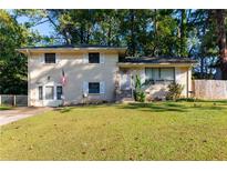 Brick ranch home with a well-manicured lawn and American flag at 3208 Edgemont Way, Decatur, GA 30032