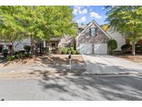 Brick house exterior with two-car garage and landscaped yard at 911 Queensbrooke Way, Mableton, GA 30126