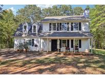 Two-story white house with black shutters and a front porch at 4012 Union Church Sw Rd, Stockbridge, GA 30281