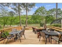 Deck overlooking a tranquil river, great for outdoor entertaining at 1053 Riverbend Club Se Dr, Atlanta, GA 30339