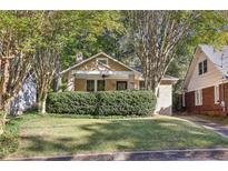 Cute bungalow with lush lawn and mature trees at 906 Courtenay Ne Dr, Atlanta, GA 30306