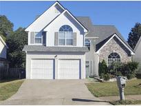 Two-story house with a double garage and stone accents at 245 Vaness Dr, Mcdonough, GA 30253