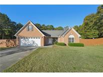 Ranch-style brick home with a two-car garage and large yard at 4011 Lafayette Way, Loganville, GA 30052