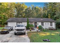 Ranch style home with a well-maintained lawn and driveway at 386 Black Oak Ct, Lawrenceville, GA 30046