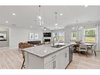 Open kitchen with island, stainless steel appliances, and breakfast area at 402 Beacon Way, Villa Rica, GA 30180
