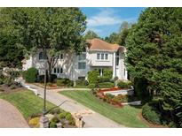 Luxury home with manicured landscaping and driveway at 1284 Waterford Green Trl, Marietta, GA 30068