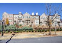 Brick townhouses with a manicured lawn and black fence at 1813 Hislop Ln, Atlanta, GA 30345