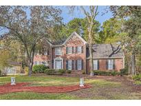 Brick house with a two-car garage and manicured lawn at 2582 Fairview Ln, Jonesboro, GA 30236