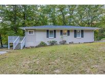 Ranch house with a large yard and wooded surroundings at 6168 Ellis St, Douglasville, GA 30134