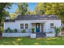 Charming ranch home with light blue siding and landscaped yard at 1714 Aircraft N Dr, Marietta, GA 30060