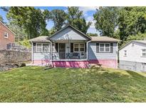 Charming house with a pink base and gray siding at 2243 Tiger Flowers Nw Dr, Atlanta, GA 30314
