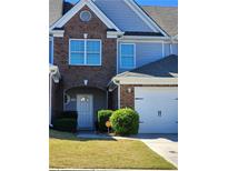 Two-story brick and siding home with attached garage at 424 Village Way, Loganville, GA 30052