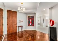 Elegant entryway with hardwood floors and art at 2660 Peachtree Nw Rd # 18G, Atlanta, GA 30305