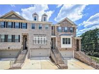 Three-story townhomes with attached garages and brick exteriors at 1333 Harris Way, Brookhaven, GA 30319