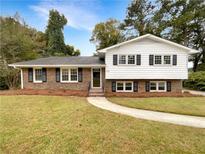 Brick ranch house with a landscaped yard and walkway at 2390 Sandgate Rd, Atlanta, GA 30349