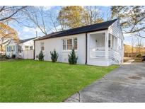 Charming white brick ranch home with a spacious lawn and modern front porch at 1246 Lyle Ave, East Point, GA 30344