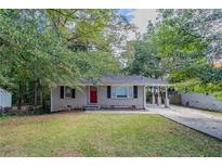 Ranch home with red door and landscaped yard at 1784 Danrich Dr, Decatur, GA 30032